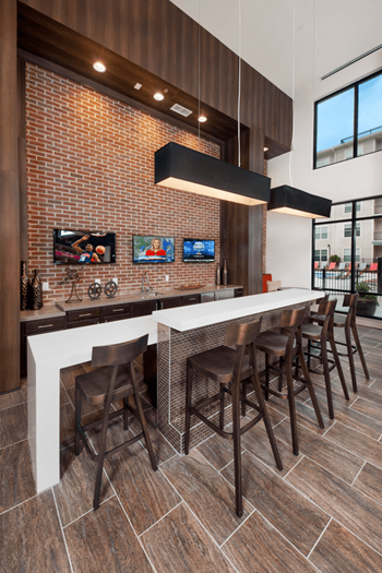 a kitchen with a long counter and stools
